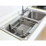 Retractable vegetable basket used as a sink drain storage rack, ideal for organized kitchen produce drying and storage.