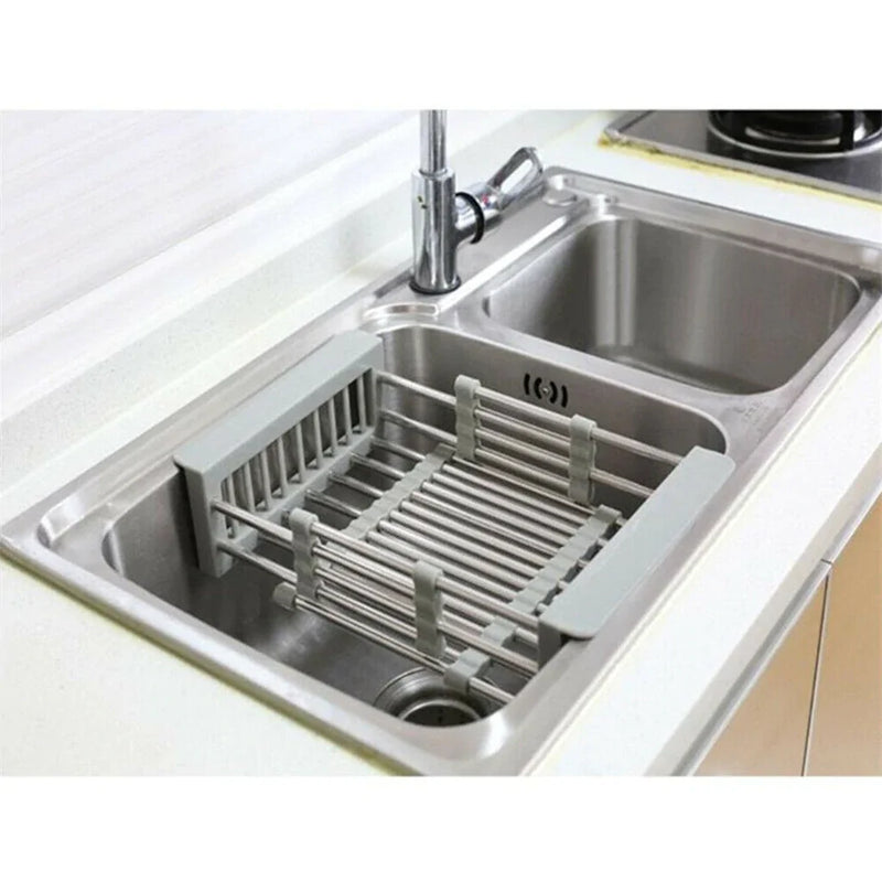 Retractable vegetable basket used as a sink drain storage rack, ideal for organized kitchen produce drying and storage.